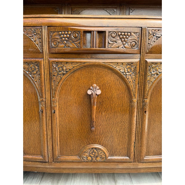 Here is a beautifully carved vintage oak sideboard, likely dating to the 1920s–1930s, featuring rich Art Deco detailing...
