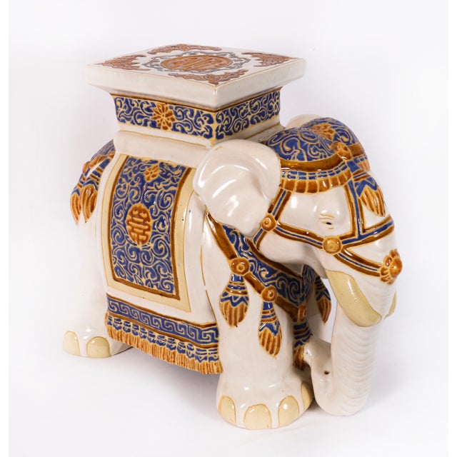 A wonderful glazed pottery garden seat or pot stand formed as an Maharaja elephant in ceremonial dress, mid 20th century...