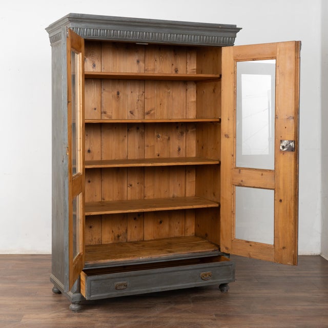 Early 20th-century Hungarian gray painted display cabinet crafted in pine. The exterior features a newer layered steel...