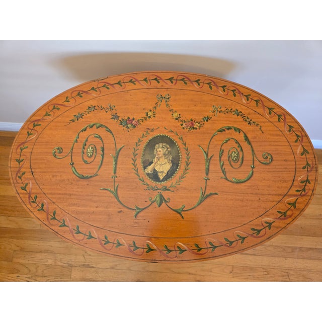 This is a hand painted side table, in the Edwardian Sheraton Revival style. It is believed to be satinwood. Central...
