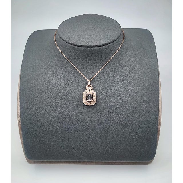A captivating 14k rose gold necklace featuring a pendant adorned with natural round-cut champagne, brown and black...