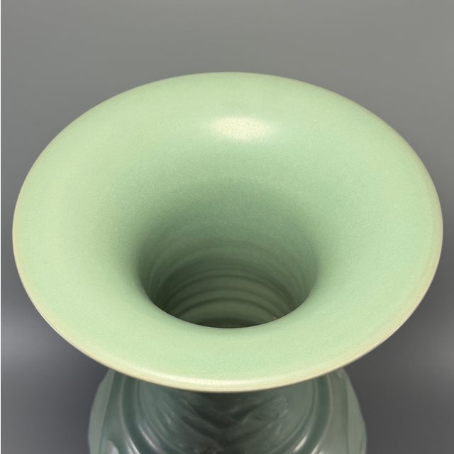 This elegant Gu-shaped vase is crafted in classic Chinese Longquan celadon style. It features a wide flared mouth,...