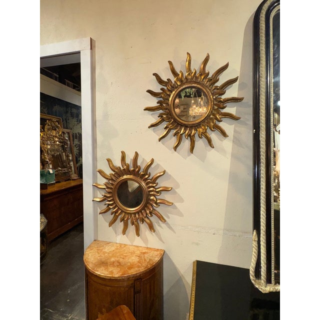 This product is a stunning pair of Italian giltwood sunburst mirrors, perfect for adding a touch of elegance to any home...