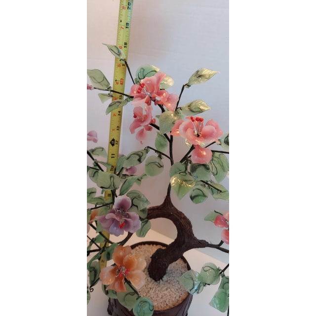 No pruning needed. This large jade glass bonzai can be arranged to your liking by bending the wire branches. Blossoms are...