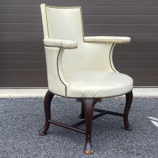 A unique high quality antique leather armchair on four cabriole legs with H stretcher. Circa early 20th century unmarked.