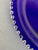 Cobalt blue glass plate. Plate is 12” in diameter with painted silver beaded edge. Use as a center decorative plate or...