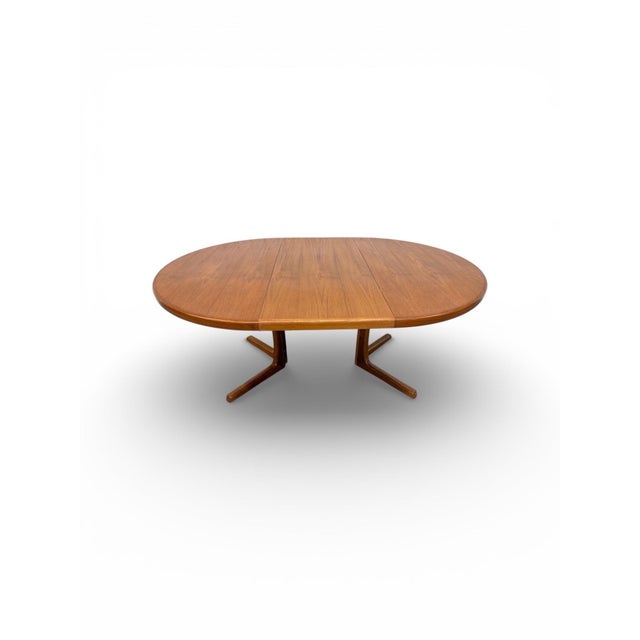 This stunning Mid-Century Danish Modern teak dining table is a timeless blend of warm wood tones and elegant Scandinavian...