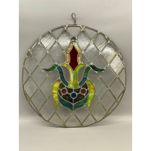 Leaded slag and clear glass jeweled architectural window. The slag glass panels range in color from carmel, light greenish...