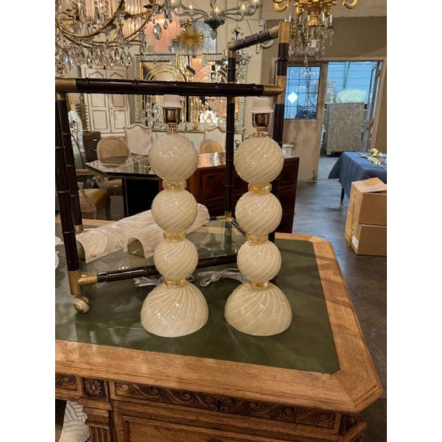 Fine pair of Murano glass ivory and gold swirl ball lamps. Circa 2000. A favorite of top designers! 22"H x 8"W