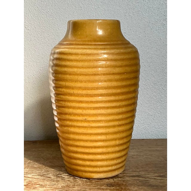 Infuse your decor with a burst of warm sunshine using this charming vintage ceramic vase. Finished in a rich, glossy...