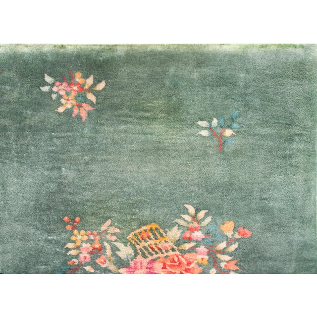 A beautiful early 20th century Chinese Art Deco rug with mint green field with a basket filled with multi-colored peonies...