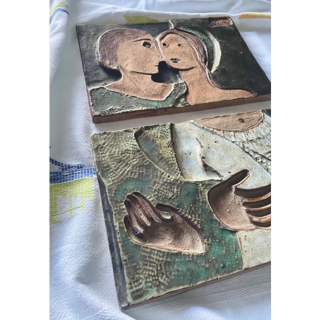 A set of two ceramic relief panels forming a figurative composition. Made of chamotte clay with grayish-green, beige, and...