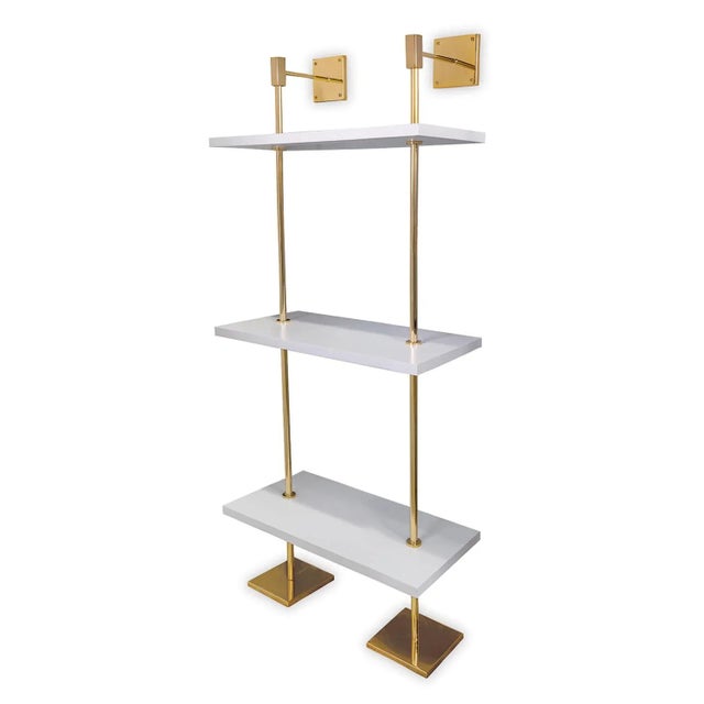 Modern multi-tier shelf in polished gold and white shelves, details urban simplicity with burnished finishes. Marais Shelf...