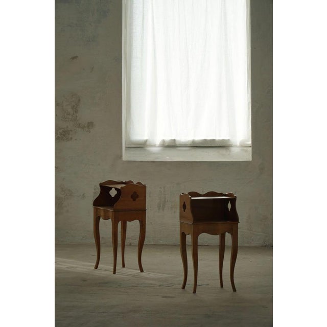 A sophisticated pair of tall nightstands / bedside tables crafted in rich nutwood, showcasing the timeless elegance of...