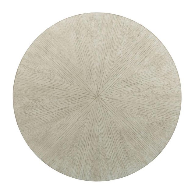 A mid century style, the refined metal columns of this cocktail table are connected with quadrant stretchers centered with...