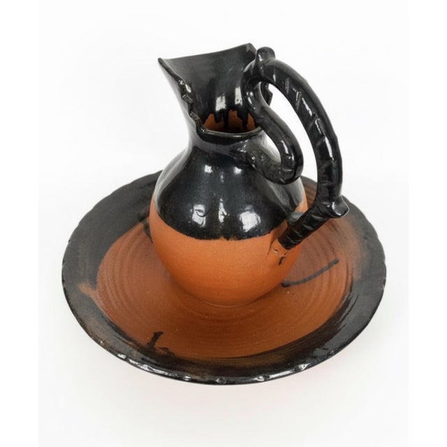 A striking signed pottery pitcher and basin set by North Carolina potter Kenneth George, part of the historic Cole family...