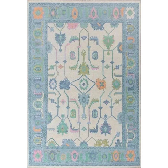 Bright Blue, Pink, with pops of Orange and Green modern handknotted oushak rug As all of our rugs are made by hand, each...