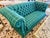 Tailored Chesterfield loveseat upholstered in a deep emerald-green wool flannel with an oversized ivory and muted-gold...
