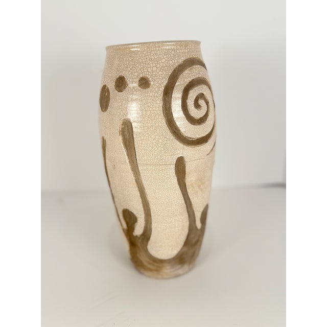 This off-white/cream crackle stoneware /earthenware vase with carved spirals is from Freehand, a long time highly regarded...