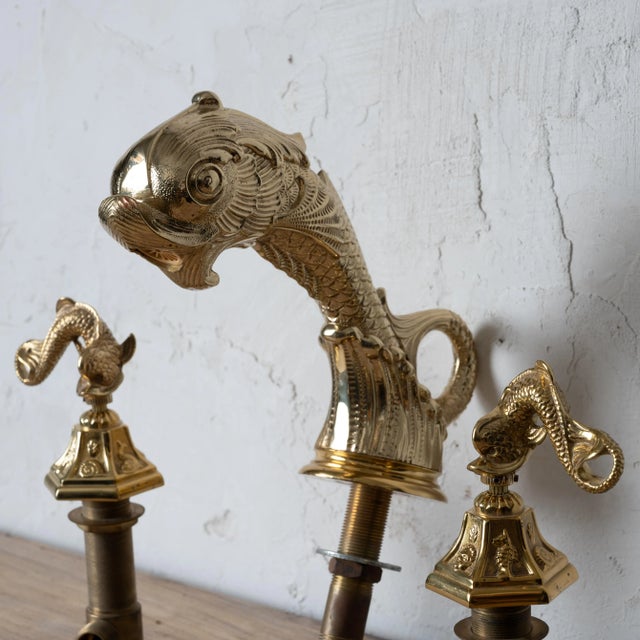 A Sherle Wagner style dolphin faucet tub set in a light polished gold. measurements not including piping: faucet: 3 inches...