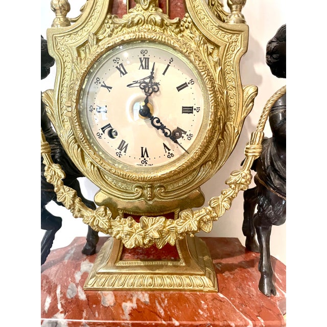 This magnificent vintage mantle or shelf clock was manufactured in Italy in the 1970s. The fine ornamental gilded ormolu...