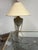 Design Plus Gallery presents a Rustic Patinated Metal Tripod Table Lamp + Laced Shade. This table lamp has a speckled...