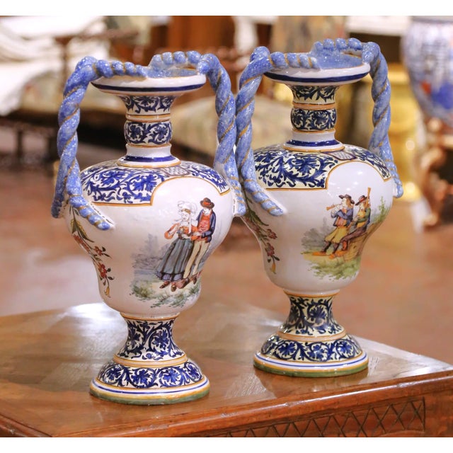 Decorate a console, sideboard, or enfilade with this charming pair of hand-painted French faience urns from Desvres....