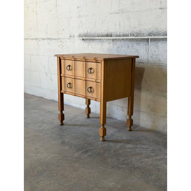 This charming small dresser features a compact rectangular profile elevated by classic turned legs. The distinctive design...