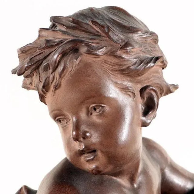 Cherub with water jug Terracotta sculpture on Verdigris marble base after a model by Albert-Ernest Carrier-Belleuse....