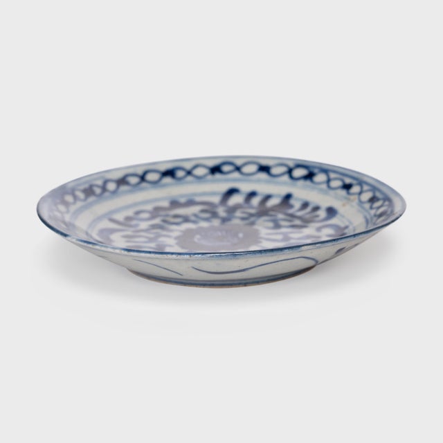 This 19th-century porcelain plate is richly decorated in the blue-and-white manner, hand-painted with dark, cobalt-blue...