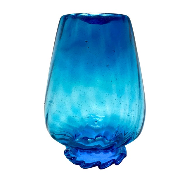 Striking large hand-blown art glass vase in a rich aqua blue tone with a sculptural serrated rim. This piece is...
