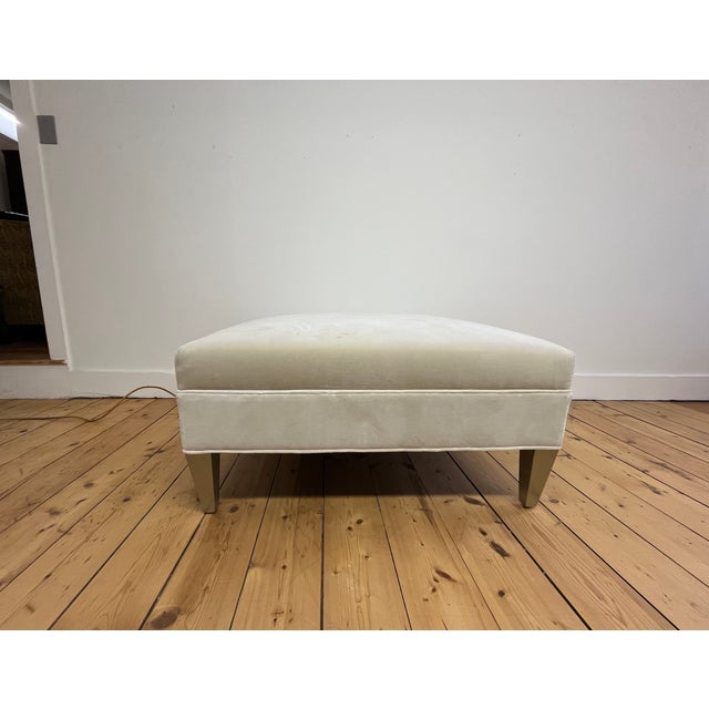 Kravet Vassar square ottoman featuring a tailored contemporary silhouette upholstered in a soft cream fabric. Designed...