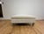 Kravet Vassar square ottoman featuring a tailored contemporary silhouette upholstered in a soft cream fabric. Designed...