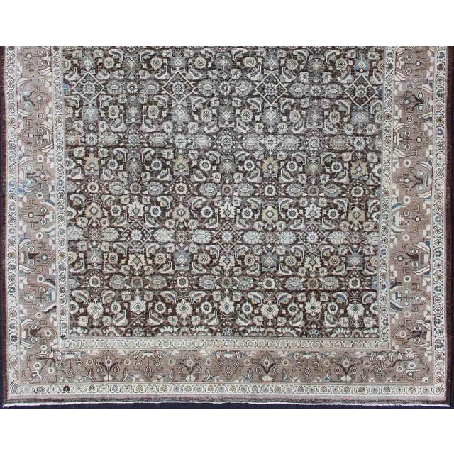 Chocolate background and light brown border antique Persian Tabriz rug with all-over Herati design and geometric border,...
