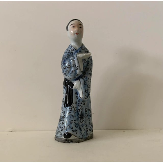 Wonderful figure of a man in decorated robe with scrolled figures. Made in China as marked.