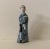 Wonderful figure of a man in decorated robe with scrolled figures. Made in China as marked.