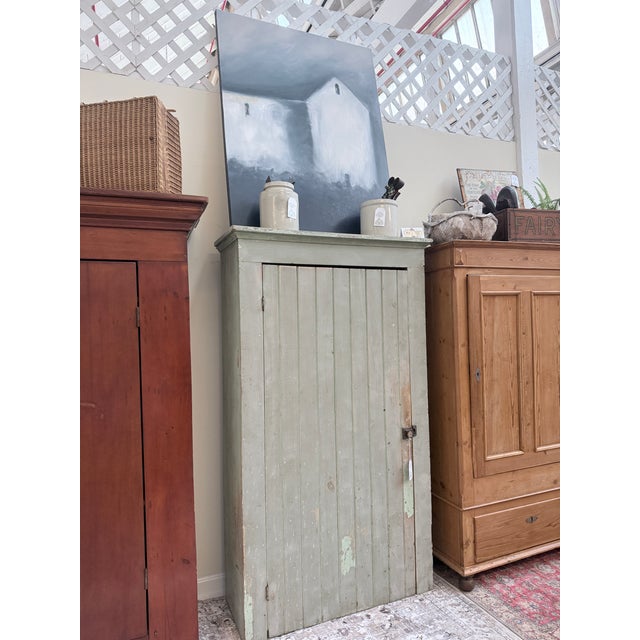 This pantry is built from solid pine, with the kind of wide, honest boards you only see in 19th‑century rural cabinetry....