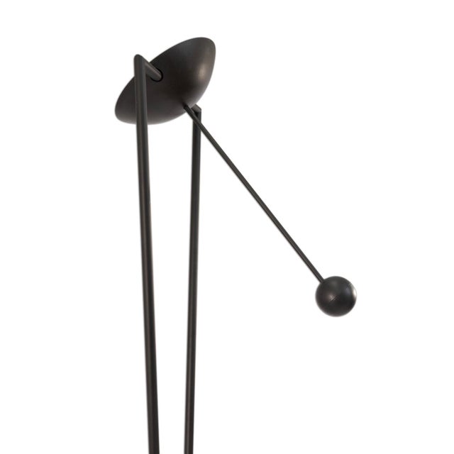 This Post Modern Pendulum Torchiere Floor Lamp by Ron Rezek is a striking example of late 20th-century design that...