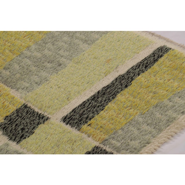 Hand-knotted in high-pile wool in Sweden circa 1960-1970, this 4x7 vintage Swedish Rya rug is a bold new addition to Rug &...