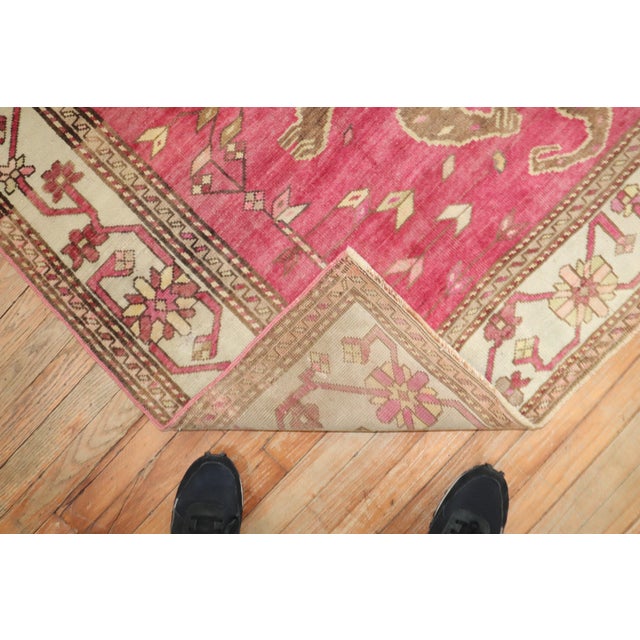 A rare armenian Rug depicting 2 Komodo Dragons on a pink fuchsia field Measures: 5'2'' x 9'4''.