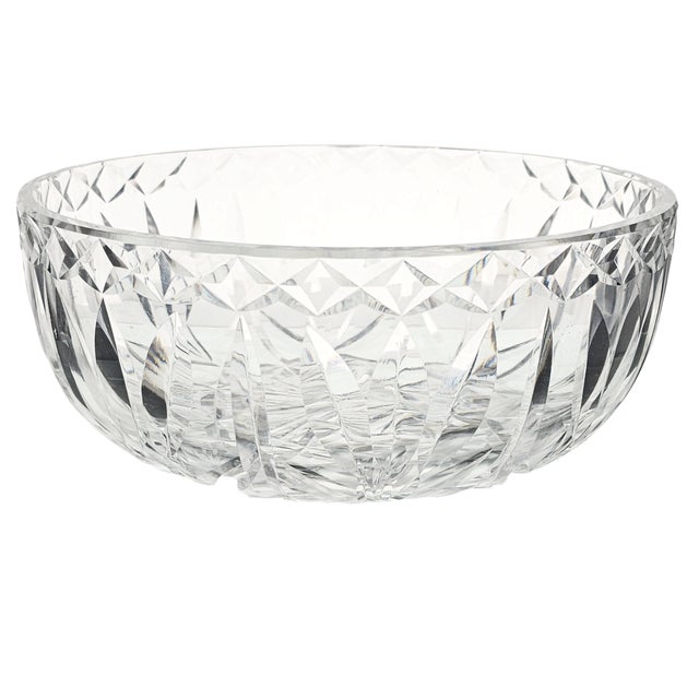 It sits like a poem on glass, its walls whispering of Irish hands and heritage. The bowl, cut with a rhythm of three-leaf...