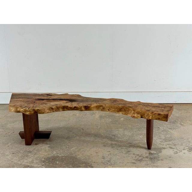 A striking sculptural coffee table or bench handcrafted from solid burl with a dramatic natural live edge profile. This...