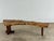 A striking sculptural coffee table or bench handcrafted from solid burl with a dramatic natural live edge profile. This...