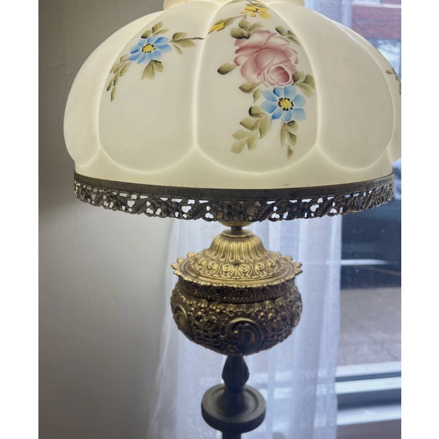 Vintage circa 1950s ornate brass electrical floor lamp. Features floral hand painted frosted glass shade in a classic bell...