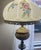 Vintage circa 1950s ornate brass electrical floor lamp. Features floral hand painted frosted glass shade in a classic bell...