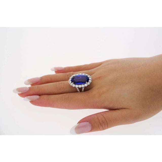 Experience the pinnacle of luxury with this exquisite ring, featuring a magnificent 15-carat oval cut natural tanzanite....