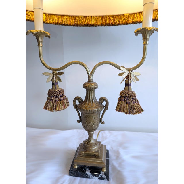 A vintage dragonfly motif double candlestick lamp with fringe silk shade by Frederick Cooper. The lamp features a cut...