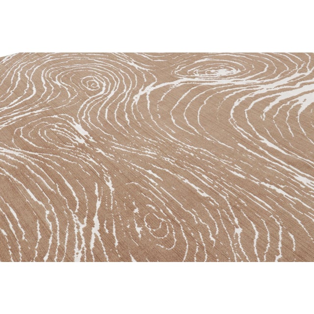 Hand-knotted in wool, this 13x10 modern abstract rug in beige-brown features a subtle high-low element married to the...