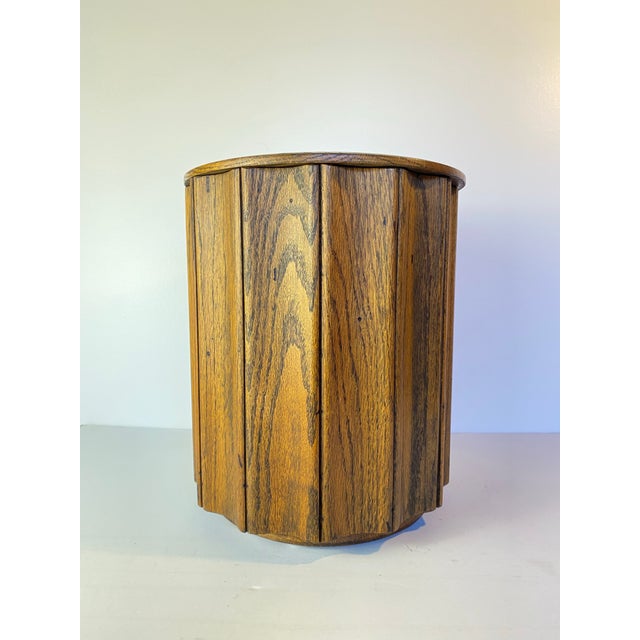 Vintage 1970s mid-century modern oak ice bucket featuring a bold fluted slat design and warm, sculptural form. The...