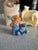 This is a charming Enesco figurine from the 'Cute as a Button' collection, featuring a child with a stuffed animal. The...